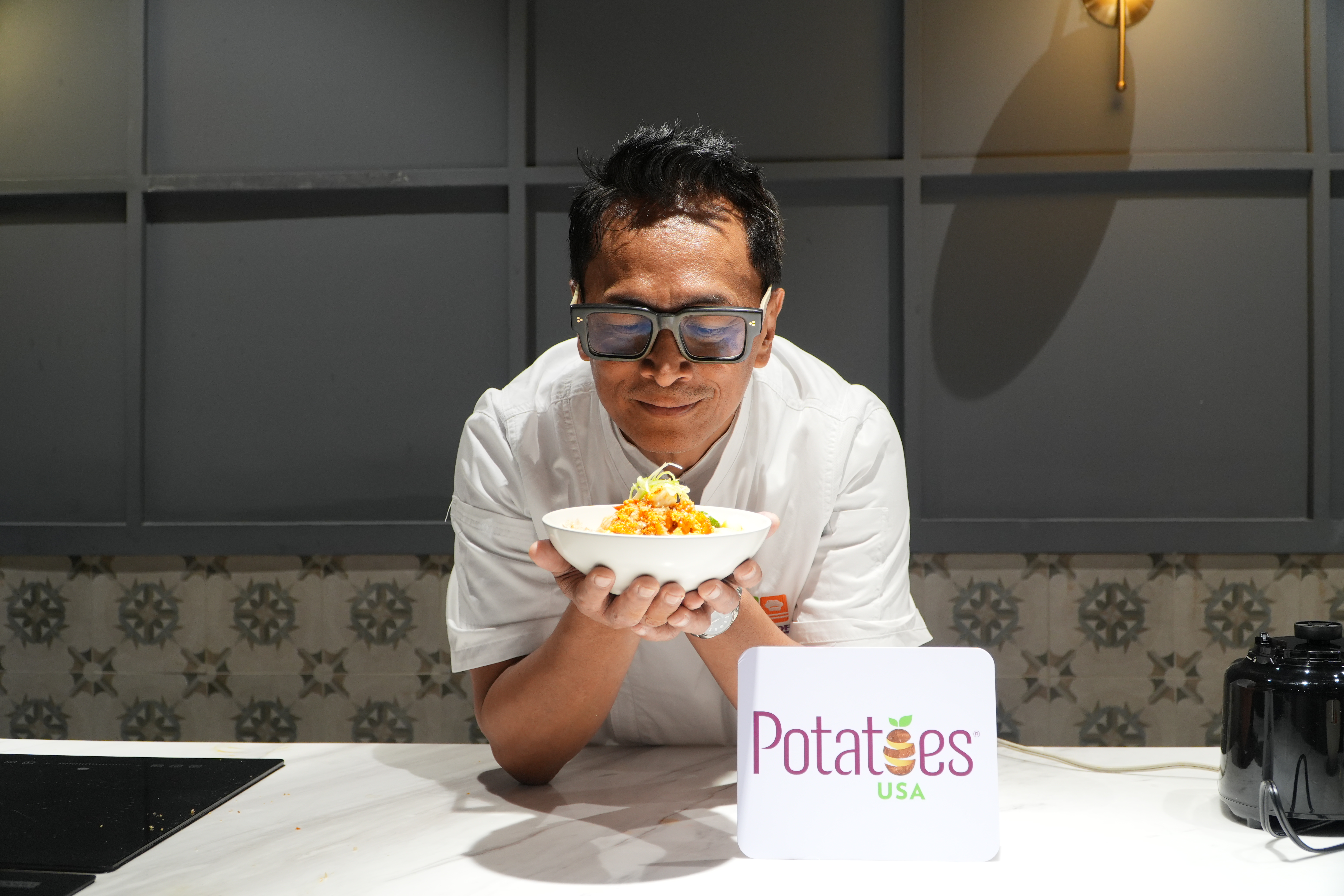 Chef Sau holding the Palabok with Potato Fries